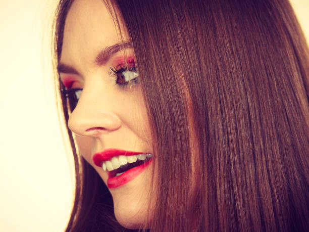 Closeup portrait of beautiful woman with bright professional make-up and manicure.
