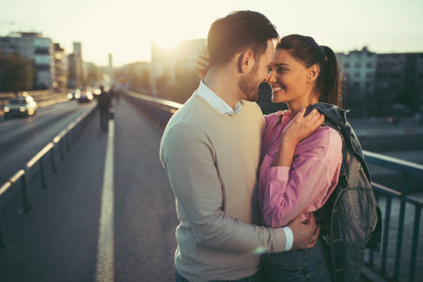 istock Young couple in love embracing on a bridge 886541384