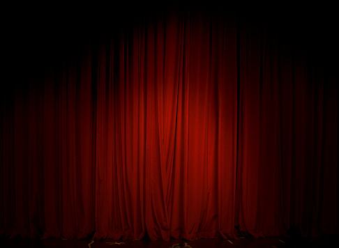 The Red Curtain in the theater is illuminated with a single reflector