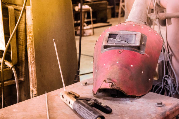 istock Broken Red welding mask with wire clamp instrument with vintage tone 886542232