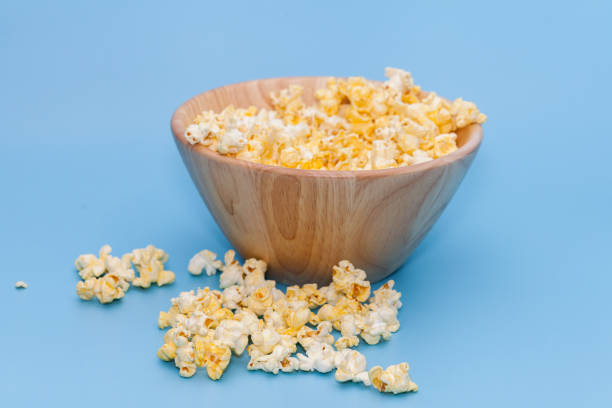 istock popcorn in wooden on blue background 886542274