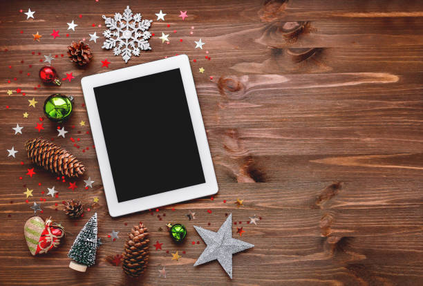 istock Christmas and New year background with tablet and decorations. Place for text. Mock up, flat lay. 886544682