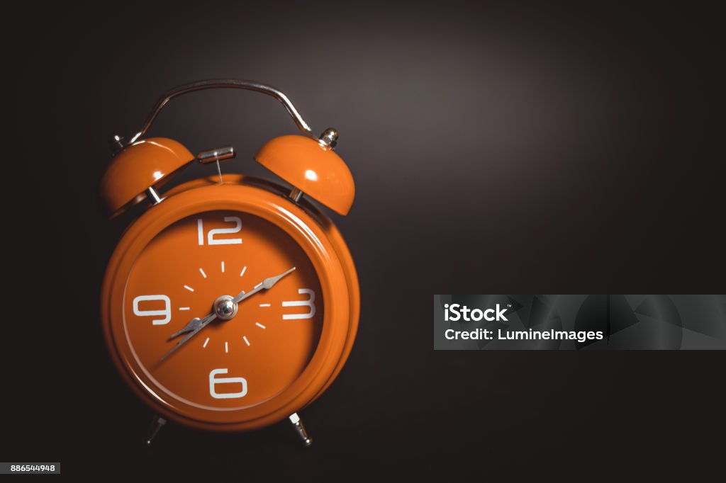 Orange retro alarm clock. Clock Stock Photo