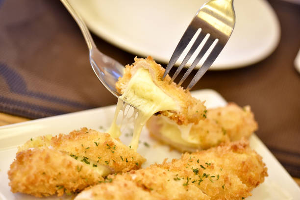 istock Deep fried pork cutlet stuffed with melted cheese, Crunchy pork cordon bleu. 886545404