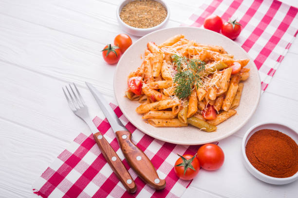 istock delicious penne pasta on wood white table 886549936