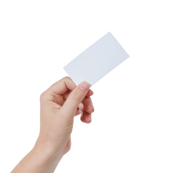 istock Left hand holds blank business or name card aloft 886552488