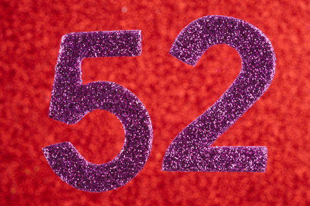 istock Number fifty-two purple over a red background. Anniversary. 886553078