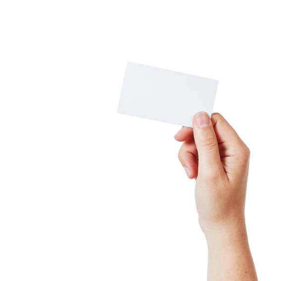 istock Hand holds a blank business card aloft against white 886554114