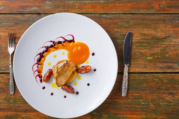 istock Roasted goose liver with date fruit and apple 886554588