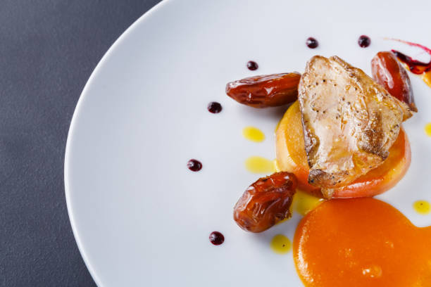 istock Roasted goose liver with date fruit and apple 886556644