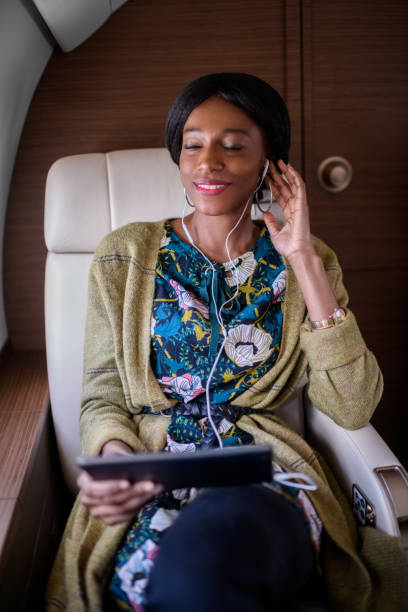 istock Woman in private jet airplane 886560542