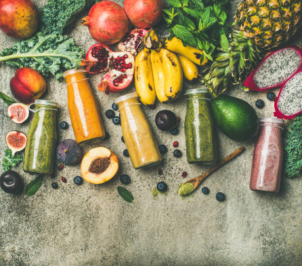 istock Colorful smoothies in bottles with fresh tropical fruit, copy space 886569758
