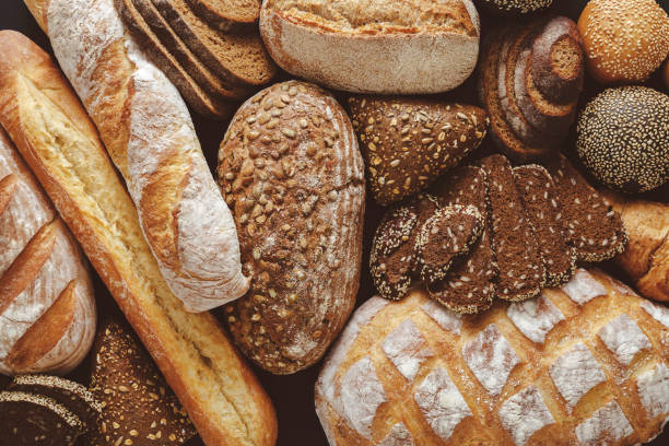 istock Bread background, top view of white, black and rye loaves 886582504