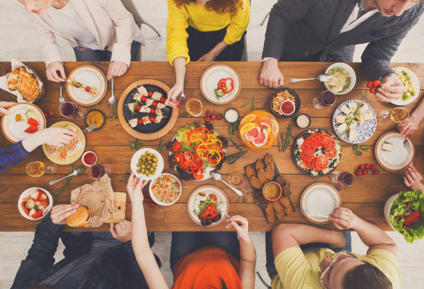 istock People eat healthy meals at served table dinner party 886592206