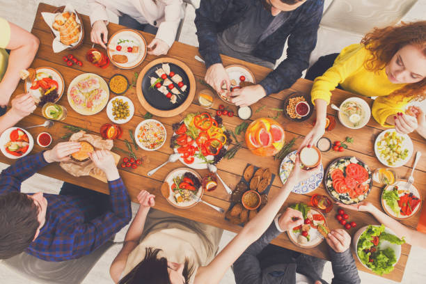 istock People eat and share healthy meals at served table dinner party 886594988