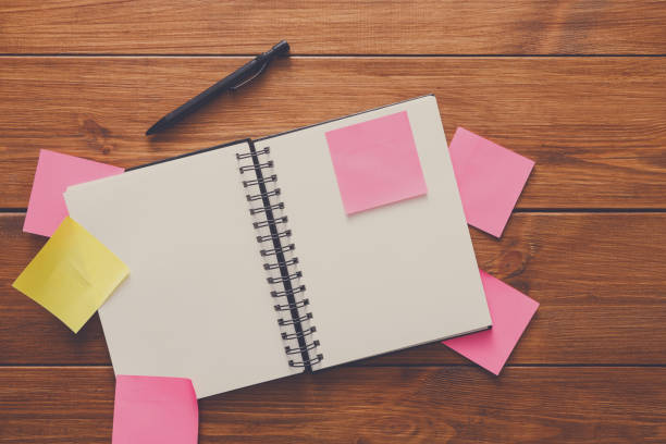 istock Top view of blank notepad on wooden office desk 886600408