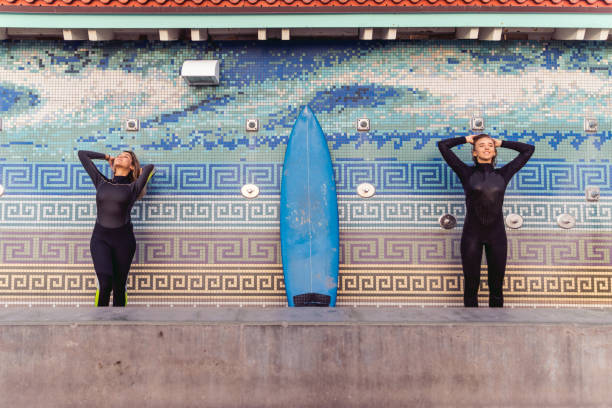 freunde, die reinigung surfbretter am ende eines langen tages am strand in kalifornien - santa monica surfing beach city of los angeles stock-fotos und bilder