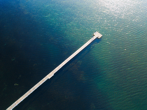 Aerial view of long jetty into the lake.