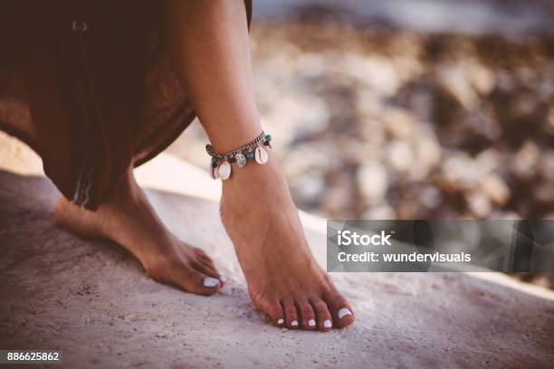 Young Woman In Boho Style Wearing Silver Ankle Bracelet Stock Photo - Download Image Now