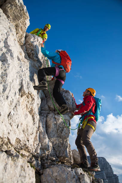 istock Hikers climbing on rocky mountain 886635564