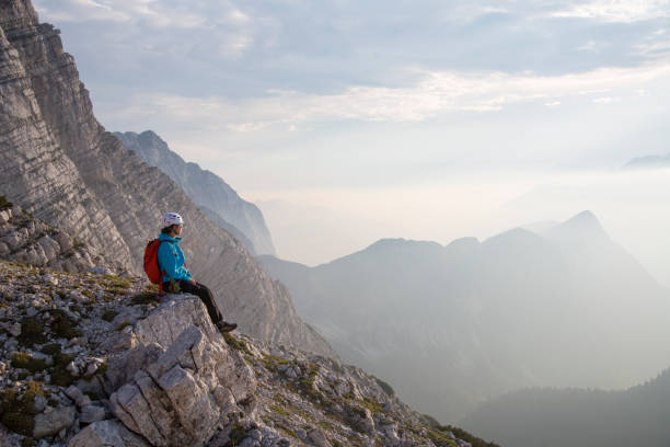 istock Female hiker sitting on the rock 886635696