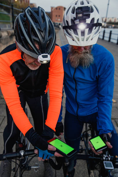 istock Two Men Looking at Chroma Key Phones on Cycle Handlebars 886635744
