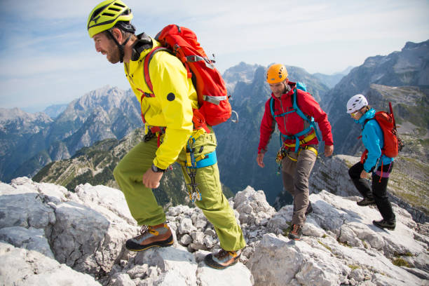 istock Hikers climbing on rocky mountain 886636028