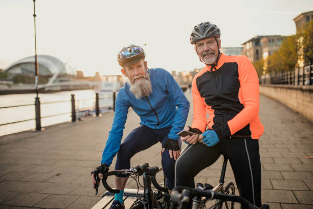 istock Two Senior Cyclists Looking at a Phone 886638860