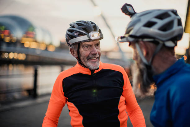 istock Two Older Cyclists One  Wearing a Helmet Camera 886639322