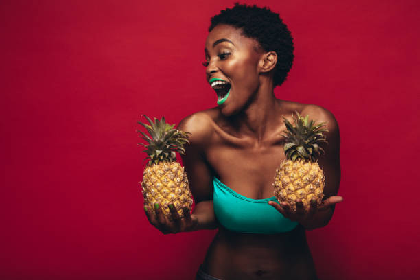 istock Black woman with pineapples in hand 886639446