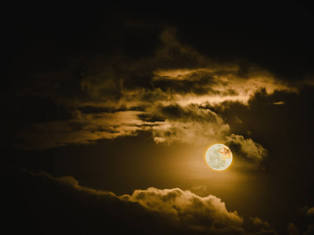 istock full moon with light and beauty cloudy sky in the dark night background 886639484