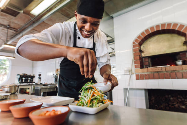 istock Male chef preparing salad in kitchen 886640190