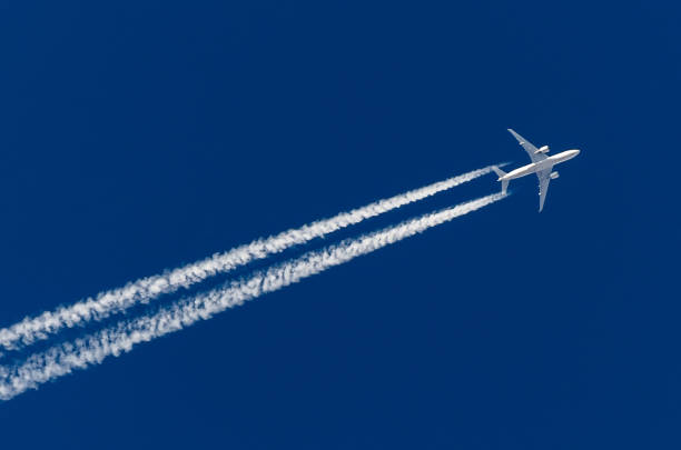 istock Airplane big four engines aviation airport contrail clouds. 886642376