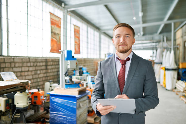 istock Successful Salesman Posing in Machine Shop 886643304