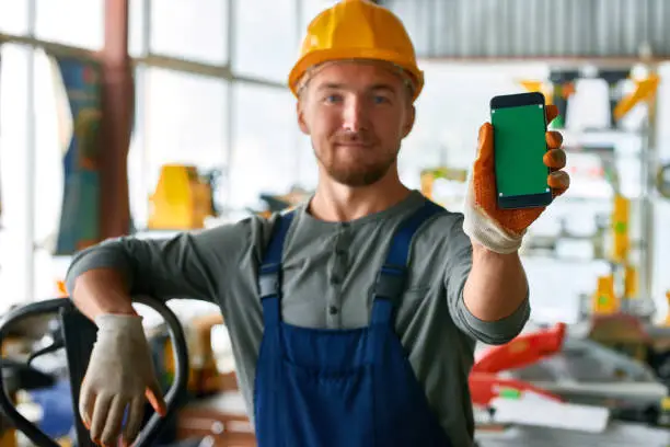 Photo of Young Workman Presenting Mobile App