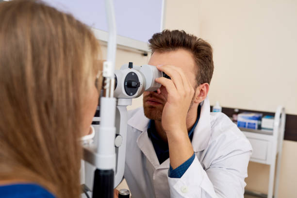 istock Young Woman Getting Eye Test at Optometrists 886643608
