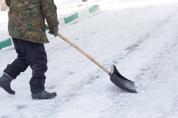 istock Worker cleans snow shovel in the nature 886646036