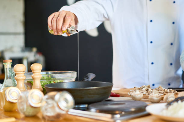 istock Unrecognizable Chef Frying Mushrooms 886649704