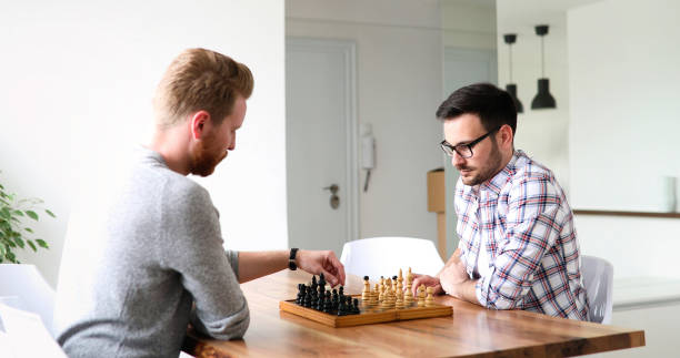 istock Portrait of two young man playing chess 886649712