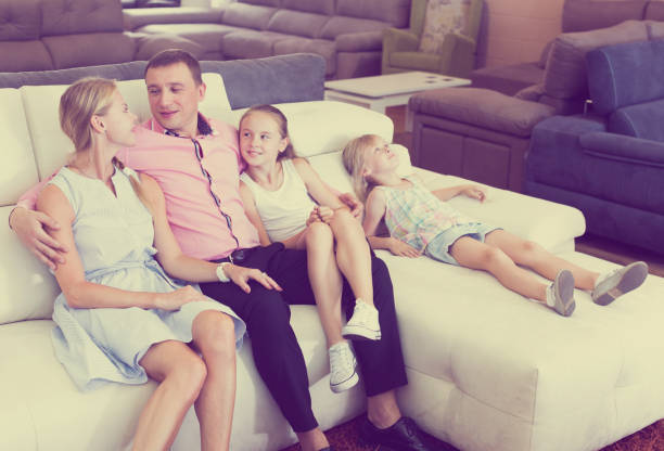 istock Parents with kids is pleased by new sofa 886650250