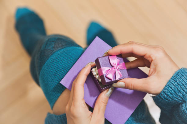 istock Female person unpacking gift 886653680