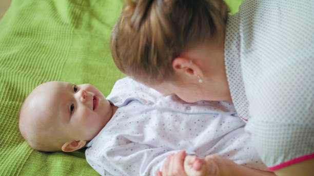 istock Mother Playning with her Baby Lying in Bed 886654098