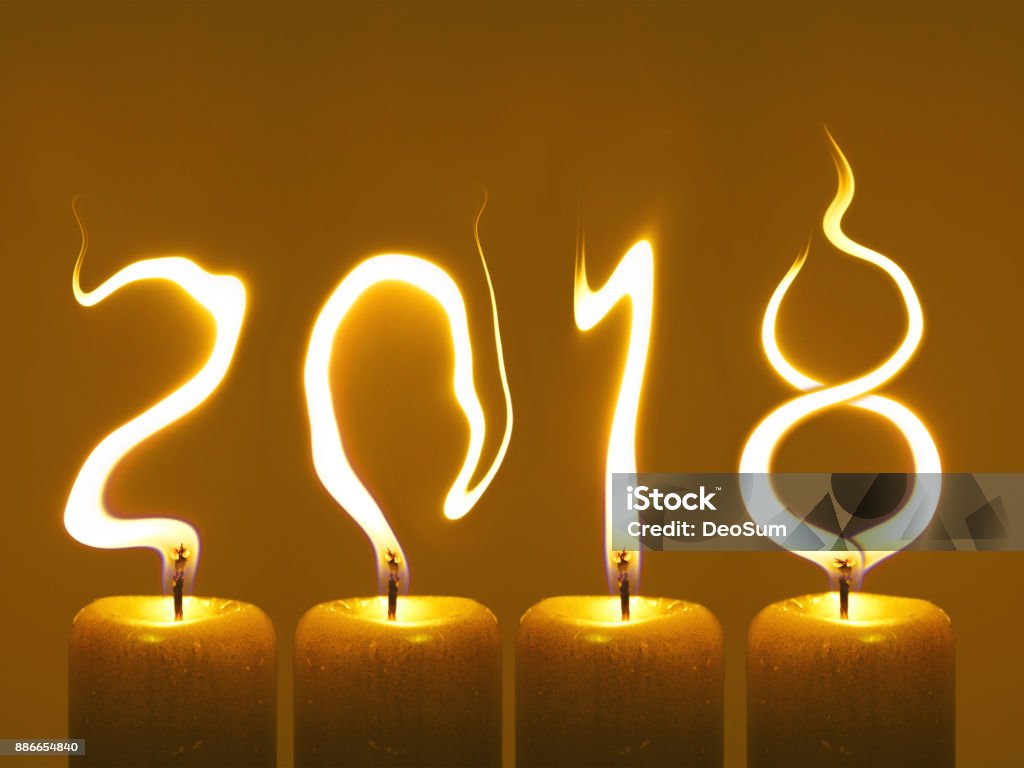 Happy new year 2018 - candles Modified photo of four candles. Flames write numbers 2018. Happy new year 2018 2018 Stock Photo