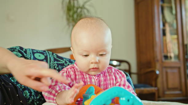 istock Baby Sitting and Playing with a Toy 886657332