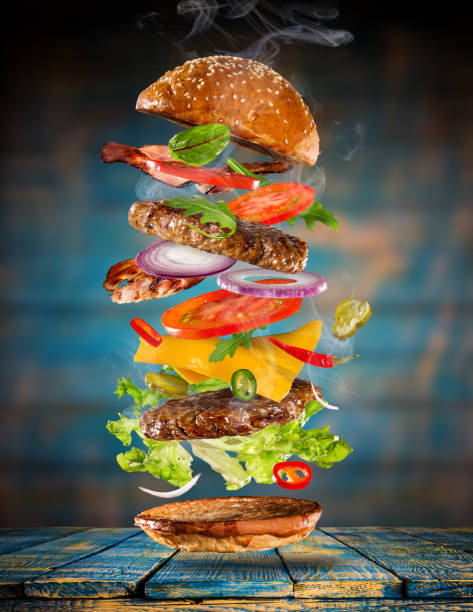 istock Big tasty burger with flying ingredients 886657726