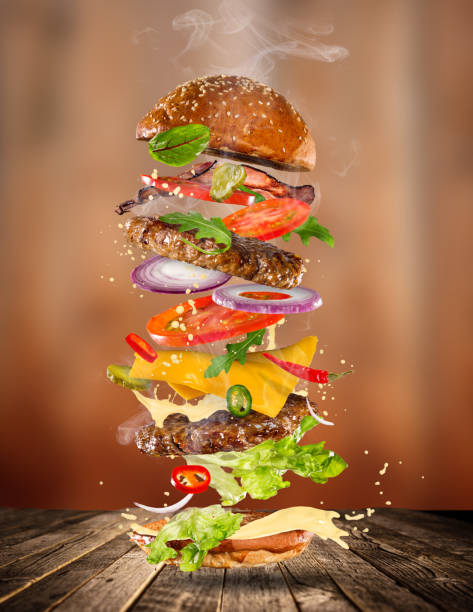 istock Big tasty burger with flying ingredients 886657770