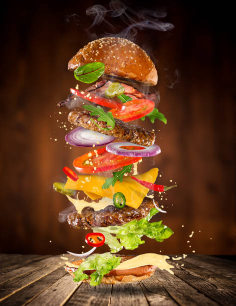 istock Big tasty burger with flying ingredients 886657844