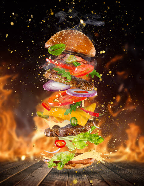 istock Big tasty burger with flying ingredients 886657922