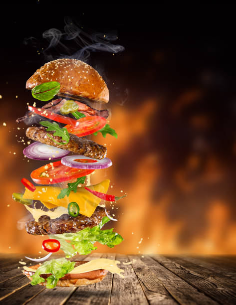 istock Big tasty burger with flying ingredients 886658020