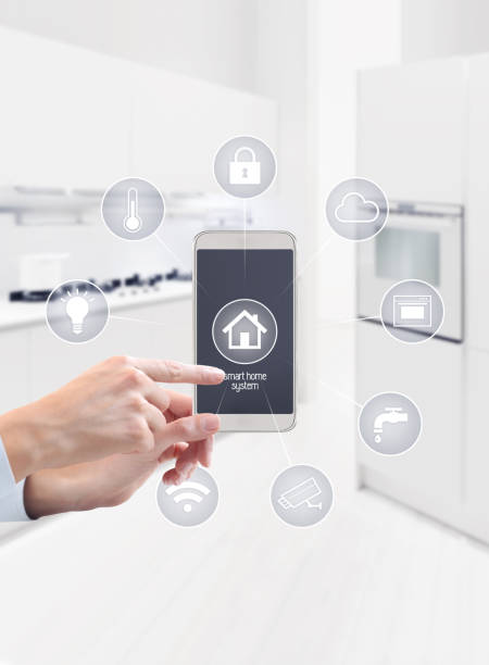 istock home automation hand touch smart phone screen with symbols on kitchen blurred background 886658202